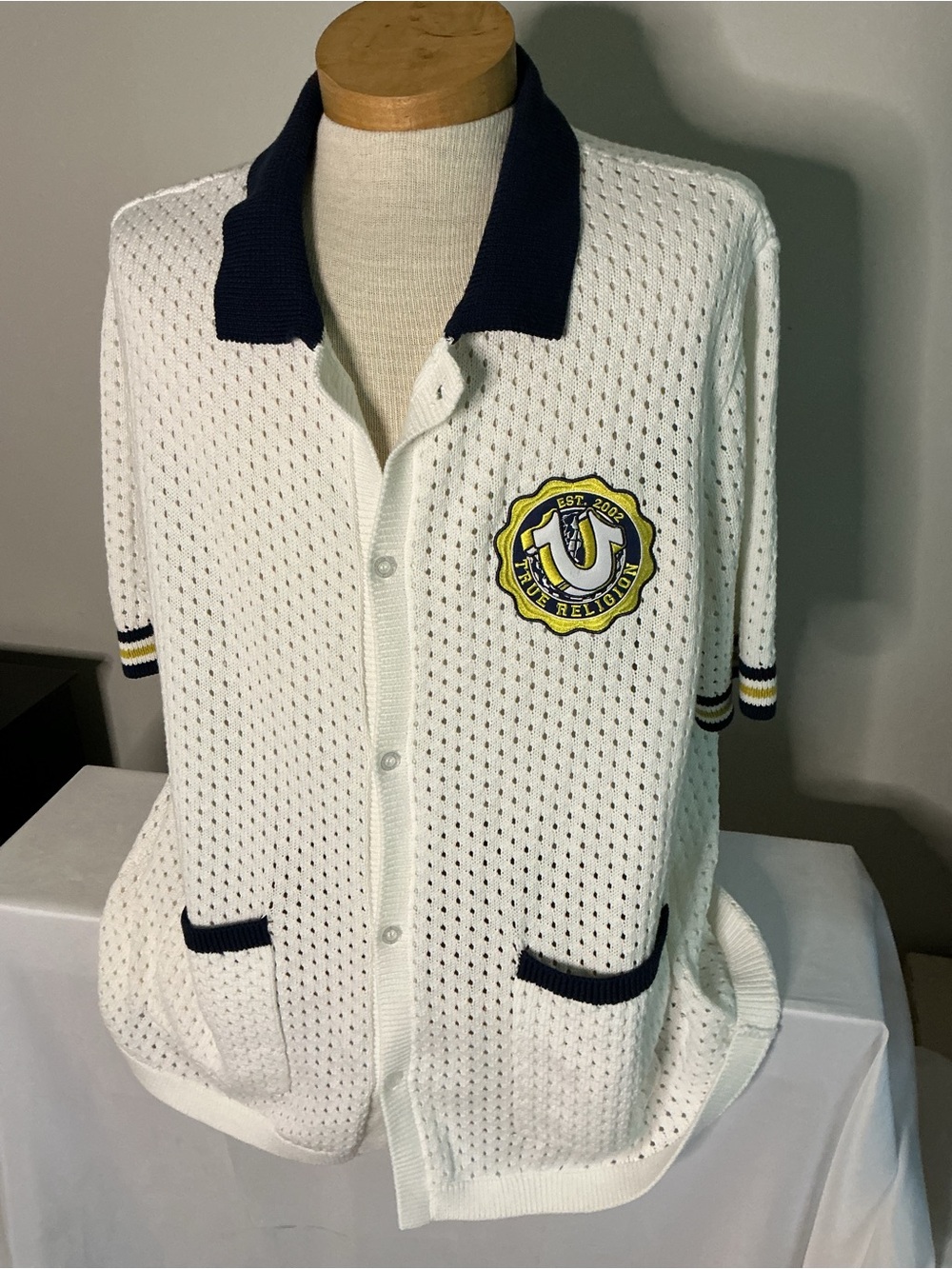 True Religion White Knit Short Sleeve Shirt with Navy Trim and Horse Shoe Crest